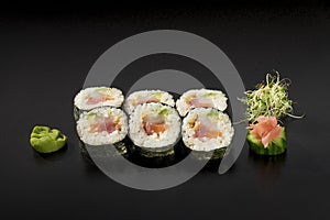 Small set sushi rolls decorated with seaweed salad