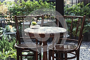 Small set tables in cafe with Antique chair thaistyle. Details of an interior