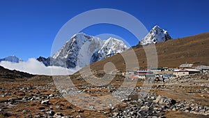 Small settlement Lobuche and snow covered mountains Tobuche, Taboche and Cholatse