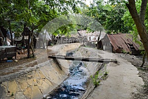 Small sewage canal surmounted by a bridge