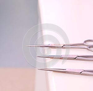 Small sharp surgical scissors placed on table unattended.