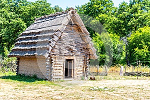 Small shepherd hut with straw roof on sunny day