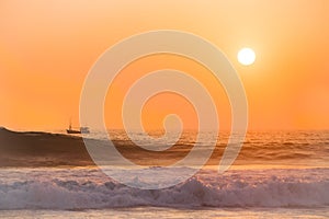 Small ship at sunset