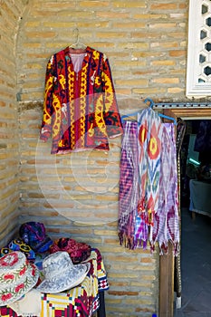 Small shop owner indian man selling shawls, clothing and souvenirs at his store.