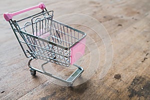 Small shopping cart,Empty shopping trolley on wooden floor