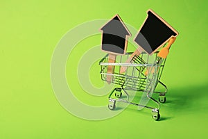 Small shopping cart with tags on color background