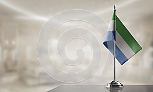 A small Sierra Leone flag on an abstract blurry background
