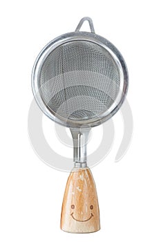 The small sieve colander with wooden handle and smile isolated o