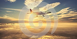 Small single engine airplane flying in the gorgeous sunset sky through the sea of clouds above the spectacular mountains photo