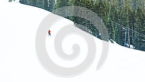 Small skier over snow mountain