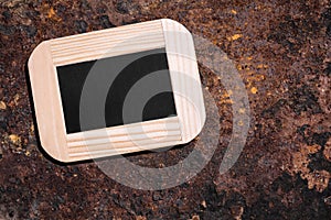 Small slate with copyspace on rusty background