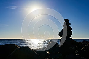 A small slide of stones against a background of blue saturated sea and sky. A picture for meditation