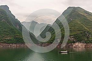 Small sloop on Yangtze and tall green mountains, Wu Gorge, Guandukou, China
