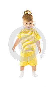 Small smiling girl in yellow pants and shirt