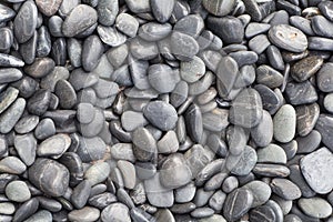 Small and smooth waterworn black pebble