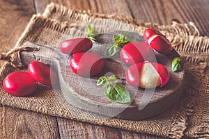 Small snack cheeses on the wooden board