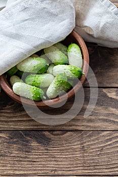 Small snack cocktail Dutch cucumbers Quirk variety on wooden background