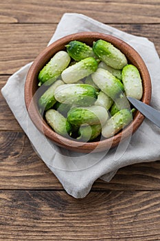 Small snack cocktail Dutch cucumbers Quirk variety on wooden background