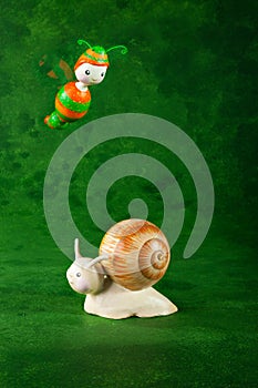 Small snail and bee, green background