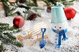 Small snowman toy with sleigh