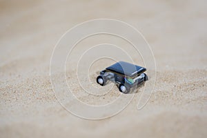 Small solar electric car on sand photo