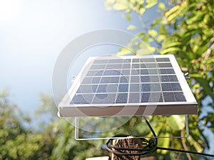Small solar panels set on outdoor poles on a sunny day. Mini solar panel for LED spotlight in the garden