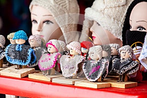 Small souvenir dolls from Nobsa in the department of Boyaca dressed with the traditional ruana and knitted hat photo