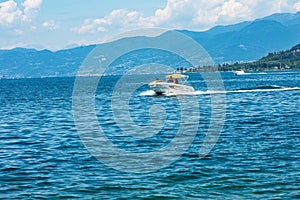 Small Speedboat with a Family on Board in motion on Lake Garda - Italy