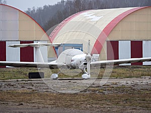 Small sport airplane on stands in a car park