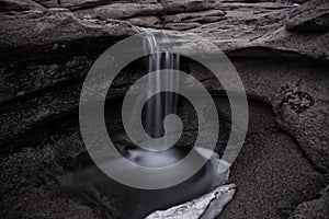 Small springtime waterfall in the moonlight