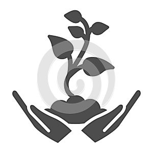 Small sprout with first leaves in soil in caring hands solid icon, gardening concept, seedling sign on white background