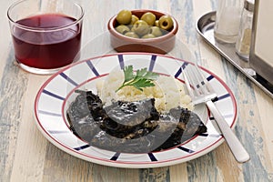 Small squid cooked in black ink, spanish basque cuisine photo