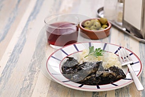 Small squid cooked in black ink, spanish basque cuisine photo