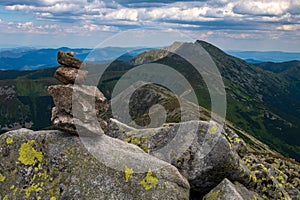 Small stack of stones against the background of majestic mountains in Low Tatras National Park.