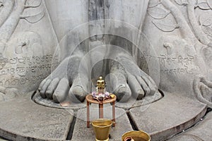 Small statue of Bahubali at the feet of the gigantic staue of Gomateshwara in Sravanabelagola photo