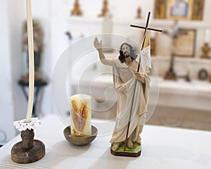 Small statue of Jesus and two candles in a small church at Masseria Il Frantoio, Southern Italy