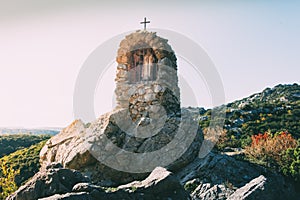 Small statue of the Virgin Mary sheltered in a stone alcove in Corbieres mountains, France