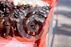 Small statues of elephants on the red table