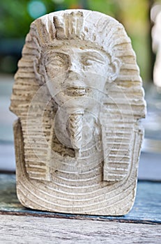 Small Statues of king pharaoh on wooden table