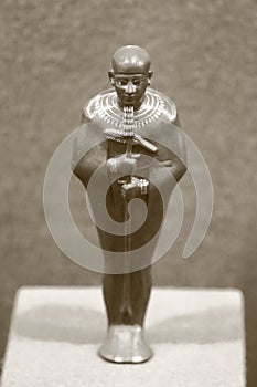 A small statuette of the god Ptah. Culture of Ancient Egypt. Black and white photo, sepia