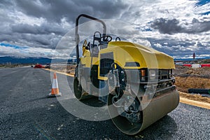 Small steamroller repairing a highway photo