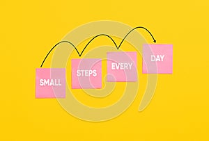 Small steps every day on stairs of note papers. Personal growth, development, progress and success concept