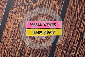 Small Steps Everyday write on sticky notes  on office desk