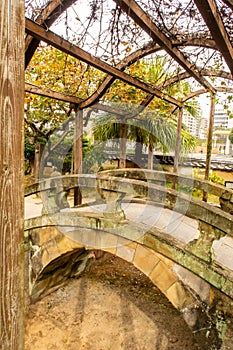Small stone arch bridge and plants in the garden on Dejima Island, former artificial island with Dutch trade post in Nagasaki. photo