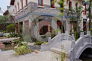 Small stone bridge with bas-relief before archaised buildings