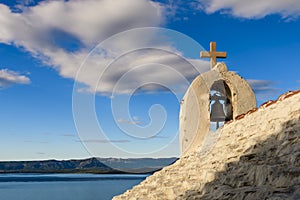 Small stone chappel in the Mediterranean, island of Brac, Croatia, Hvar in background