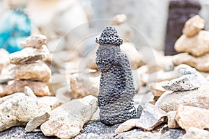 Small stone figure of hareubang Jeju island idol , shot in prayer place of buddist temple South Korea