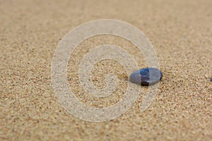 Small stone on the sandy beach,