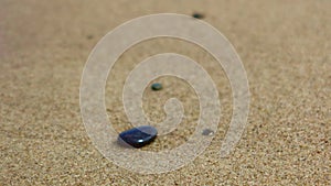 Small stone on the sandy beach,
