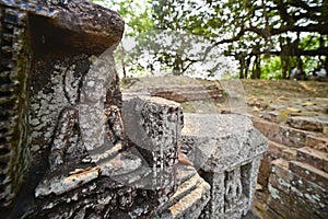 Small stone sculpture of Buddha on display at Ratnagiri Buddhist archaeological site, Odisha, India.